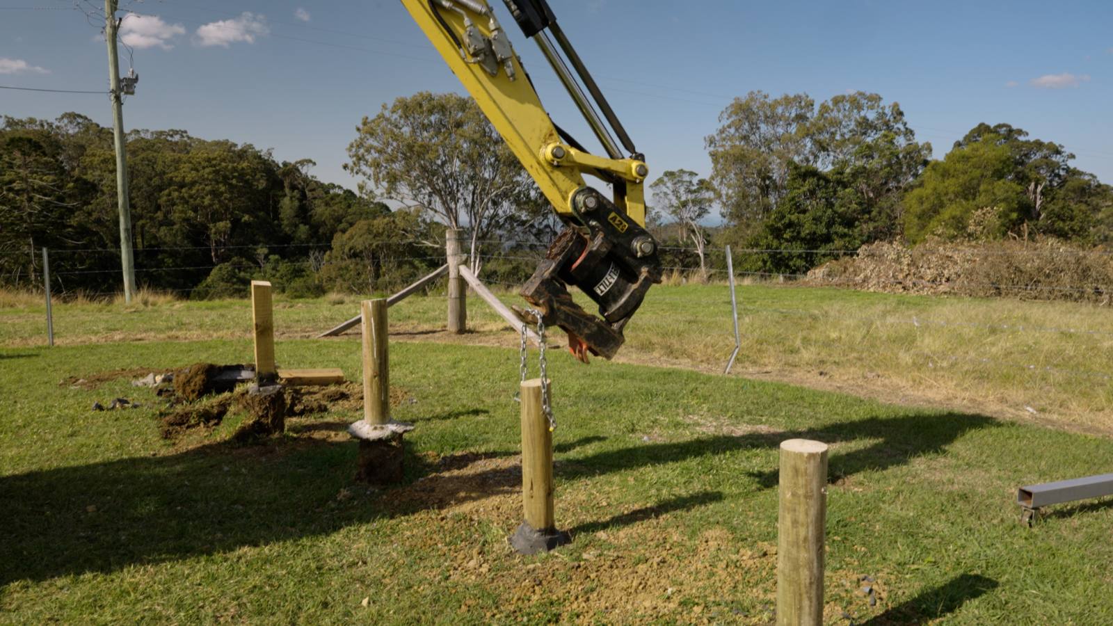 Excavator lifting on a TuffSpec-set post